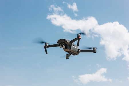 Drone pressure washing for hard to reach exterior cleaning